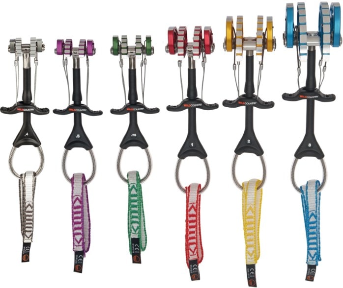 Close-up of Wild Country climbing cam set showing high-friction lobes and ergonomic trigger design.