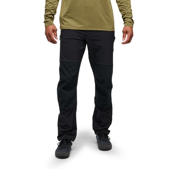 Front view of Men's Alpine Performance Climbing Pants in action on a rock face.