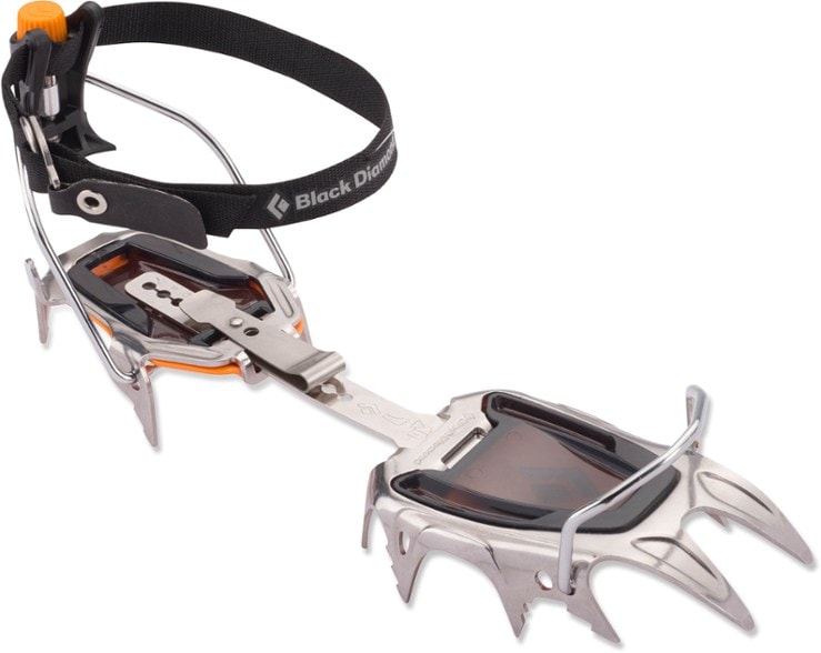 Side view of Sabretooth Pro crampons on rugged terrain, highlighting their design and fit.