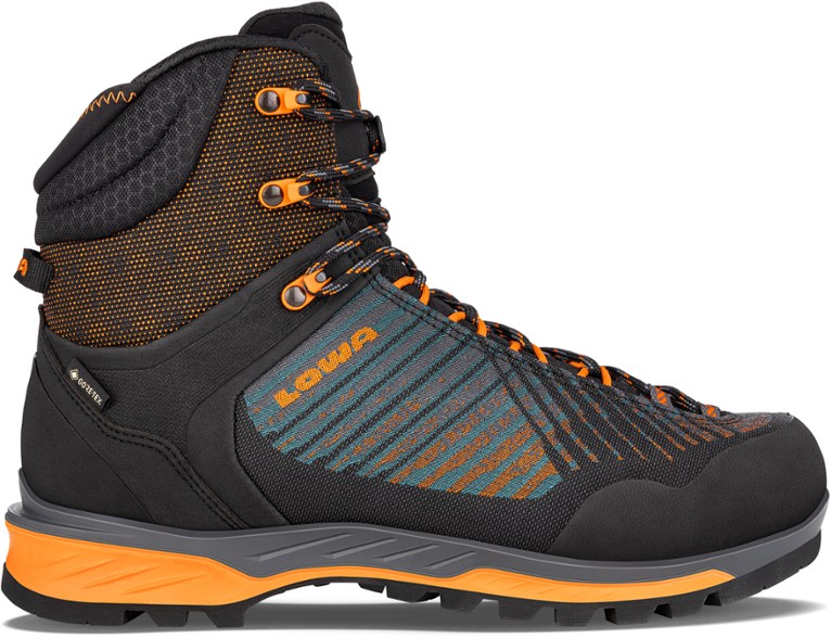 Men's Lowa Mangart GTX Mid mountaineering boots showcasing the GORE-TEX waterproof feature on rugged terrain.