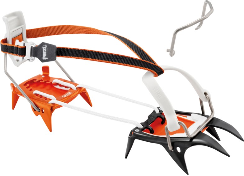 Petzl Irvis Hybrid crampons displayed on snow with a mountainous backdrop.