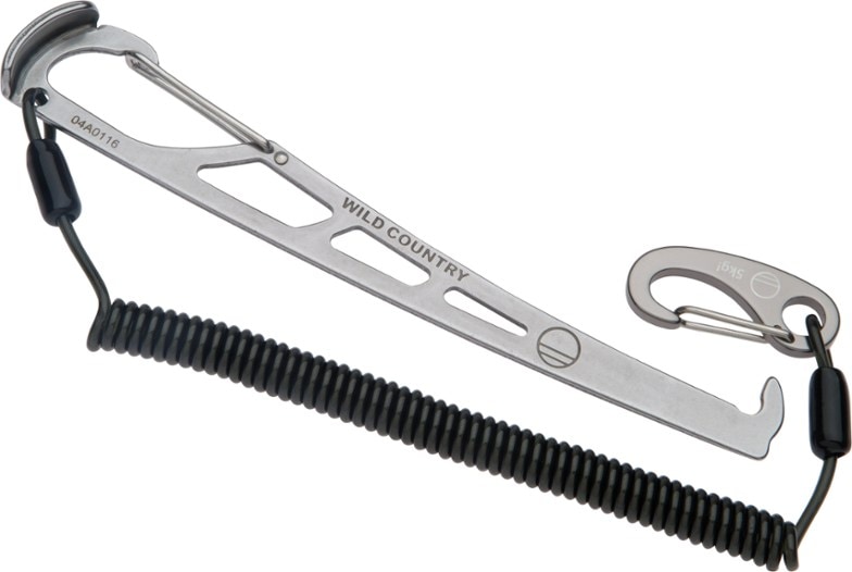 Pro Key Nut Tool displayed against a rocky backdrop, highlighting its ergonomic design for climbers.