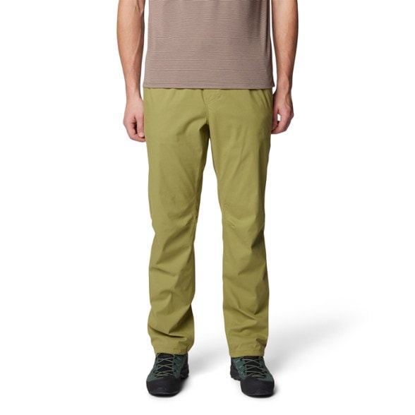 Front view of men's climbing pants showcasing flexibility during a hike.