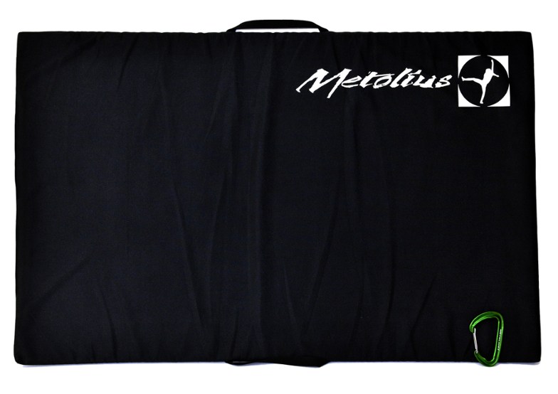 Top-down view of TrailNest compact bouldering pad placed over a gap between two larger crash pads outdoors.