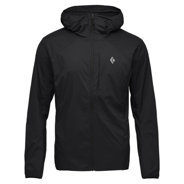 Alpine Shield jacket showcased on a climber in windy conditions, demonstrating its lightweight and packable features.